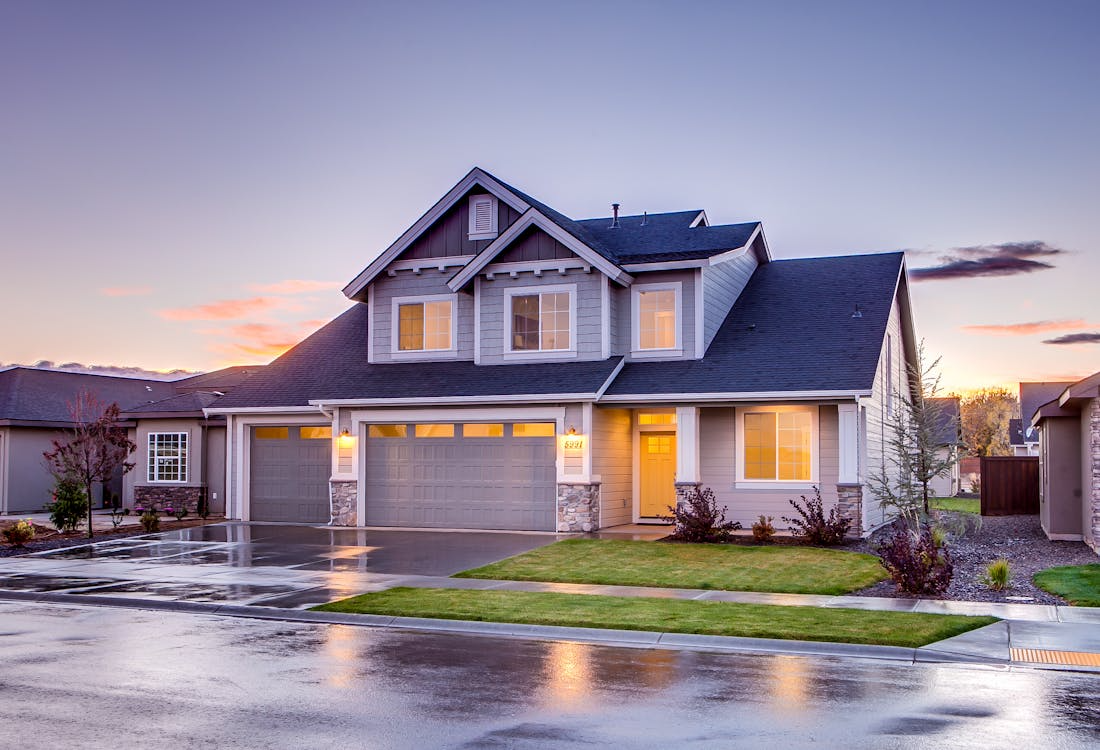 Beautiful modern home exterior at sunset showcasing professional maintenance and curb appeal